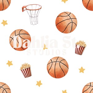 May include: Watercolor pattern featuring basketballs, popcorn, a basketball hoop, and star shapes on a white background. The basketballs are orange with black lines. The popcorn is in a red and white striped container. The text "Dahlia Studios" is visible.