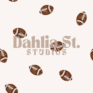 May include: A seamless pattern featuring brown and white footballs on a white background. The text "Dahlia St. STUDIOS" is centered on the pattern.