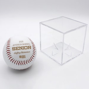 May include: White baseball with red stitching and gold lettering. The ball says "2025 Jefferson Baseball Senior Jeffrey Nickleson #21". The ball is in a clear plastic display case.