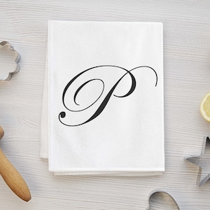 May include: White kitchen towel with a black cursive letter "P" in the center.
