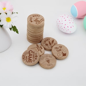 May include: Wooden tokens with different date night ideas, including "Movie Night", "Board Game Night", "Sweet Treat Time", "Ice Cream Date", and "Stay Up Late".