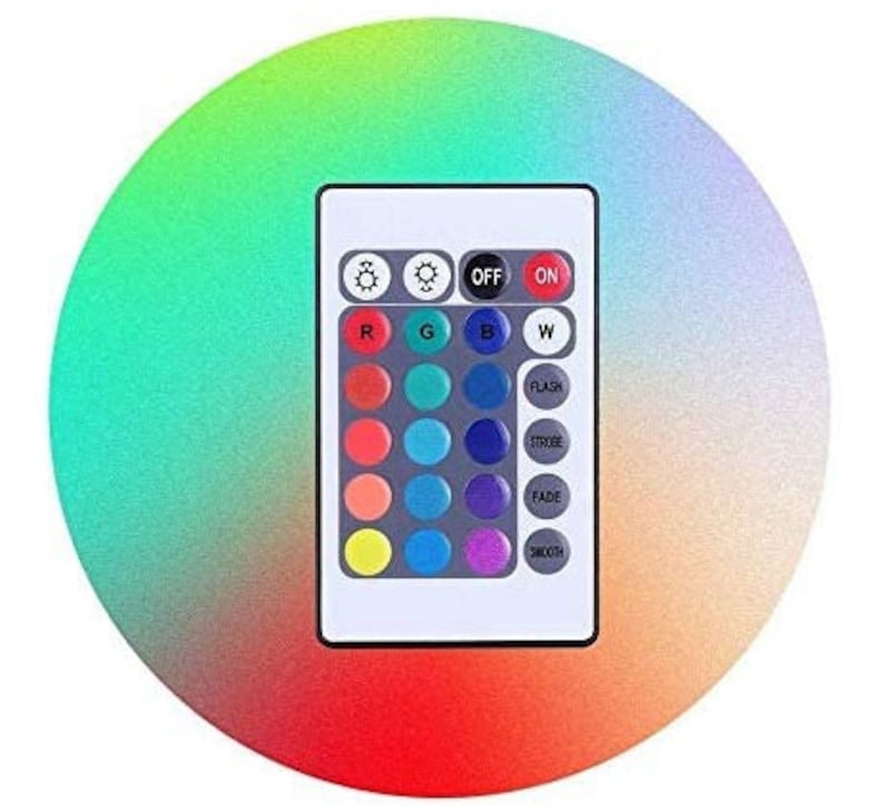 May include: A white remote control with a variety of buttons, including "ON", "OFF", "FLASH", "STROBE", "FADE", and "SMOOTH". The remote control has a grid of colored buttons, including red, green, blue, and white.