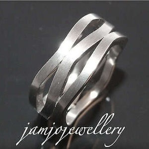 May include: A silver stainless steel ring with a woven design. The ring is wide and has a polished finish.
