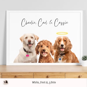 May include: A white framed print with a black background and the text "Charlie, Carl & Cassie" in black. Three dogs are pictured, a white Labrador Retriever, a brown and white poodle, and a brown Cocker Spaniel. A yellow halo is above the Cocker Spaniel.