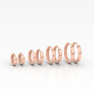 May include: A white ceramic mug with a black handle and the text "But First, Coffee" in a black, handwritten-style font. The mug is on a white surface.