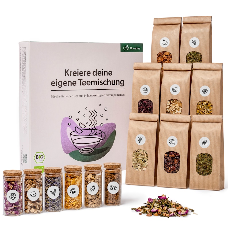 May include: A box of 14 different tea blends in individual brown paper bags. The box is labeled "Kreiere deine eigene Teemischung" and "Mische dir deinen Tee aus 14 hochwertigen Teekomponenten". There are also 8 small glass jars filled with different tea blends.