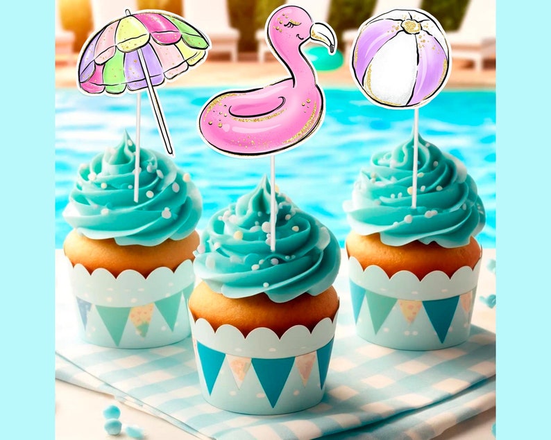 May include: Three cupcakes with blue frosting and decorative toppers. The toppers include a beach umbrella, a pink flamingo float, and a beach ball. The cupcakes sit in light blue and white patterned wrappers, with a pool in the background.