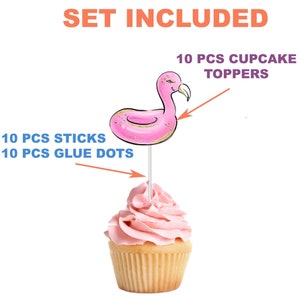 May include: A cupcake topped with pink frosting and a flamingo-shaped topper. The topper is pink with gold glitter accents and a silver stick. The image includes text that says "SET INCLUDED", "10 PCS CUPCAKE TOPPERS", "10 PCS STICKS", and "10 PCS GLUE DOTS".