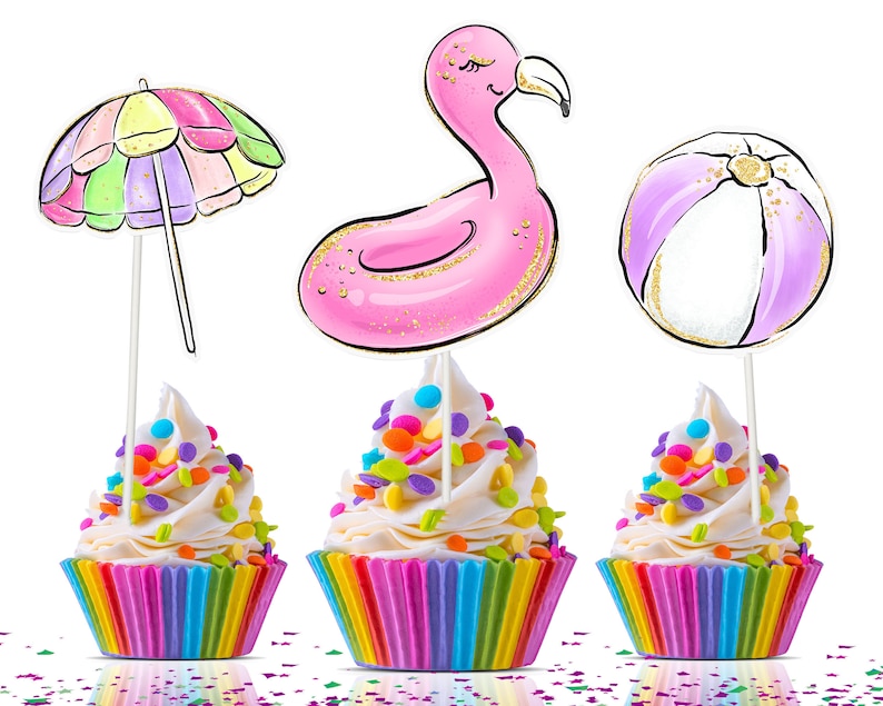 May include: Three cupcakes with colorful rainbow-striped wrappers, topped with white frosting and sprinkles. Each cupcake has a decorative topper: a beach umbrella, a pink flamingo float, and a beach ball. The toppers have gold glitter accents.