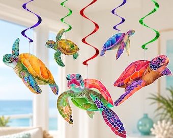 May include: A set of five hanging decorations featuring colorful sea turtle illustrations suspended from metallic purple, green, and red spiral swirls. Each turtle displays a unique watercolor-style pattern with vibrant shades of orange, green, blue, and pink.