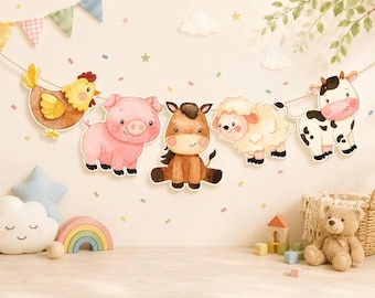 May include: A decorative garland featuring five watercolor-style farm animal cutouts: a yellow chicken, a pink pig, a brown horse, a cream-colored sheep, and a black and white cow, all strung together on a thin cord against a light background.