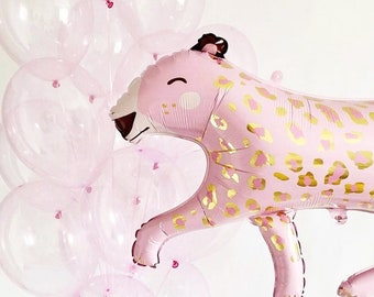 May include: A pink and gold leopard print foil balloon. The balloon is shaped like a leaping leopard with a cute face. The balloon is surrounded by a cluster of clear pink balloons.