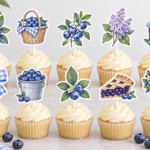 May include: A set of ten decorative cupcake toppers featuring watercolor illustrations of blueberries, a woven basket, a metal bucket, a slice of blueberry pie, a floral wreath, a blue gingham bow, a jar of jam, and purple lilac flowers.