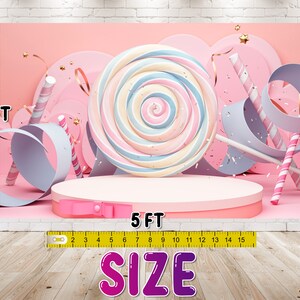 May include: A pink and white candy-themed backdrop with a large lollipop, candy canes, and ribbons. The backdrop is 3 feet tall and 5 feet wide.  "SIZE" is written in large pink letters at the bottom of the image.