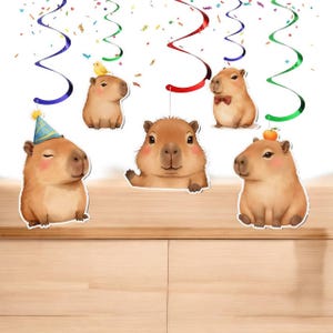 May include: A collection of whimsical capybara cutouts with party decorations. The capybaras are in various poses, some wearing party hats and bow ties. Colorful streamers and confetti add to the festive atmosphere. The overall theme is a celebration.