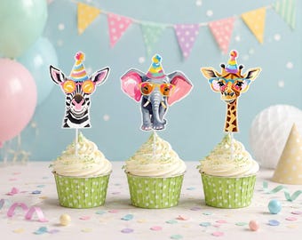May include: Three cupcakes in green polka-dot liners, each topped with a paper animal cutout on a stick. The cutouts feature a zebra, an elephant, and a giraffe, all wearing colourful party hats and bright-rimmed glasses against a festive backdrop.
