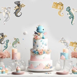 May include: A three-tiered white cake topped with a blue dragon figurine, surrounded by smaller cakes, cupcakes, and dragon-themed paper cutouts. The display features pastel-colored floral accents, pink clouds, and various dragon illustrations.