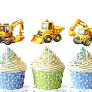 May include: Three yellow construction vehicle cupcake toppers with blue and green frosting cupcakes.