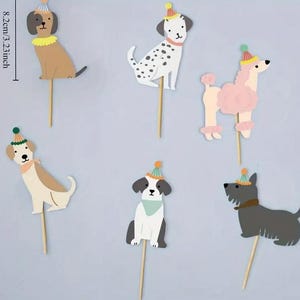 May include: Set of 6 dog-themed cake toppers. Each topper features a different breed of dog wearing a party hat. The dogs are in various colours, including black, white, brown, pink, and grey. The toppers are 8.2 cm or 3.23 inches tall.