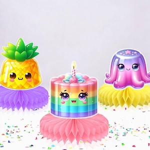 May include: Three cartoon-style decorations: a pineapple, a rainbow cake with a candle, and a purple octopus. Each sits atop a colorful honeycomb paper base. Confetti is scattered around the base of the decorations.