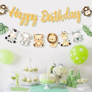 May include: A birthday party scene with a gold glitter banner reading "Happy Birthday". The banner is decorated with animal cutouts: a zebra, elephant, tiger, lion, giraffe, and hippo. Green balloons and a cake are part of the party decorations.