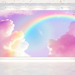 May include: A pastel rainbow arching over fluffy pink and yellow clouds against a light blue sky. This backdrop is perfect for a whimsical photo shoot.