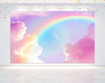 Pode incluir: Um arco-íris pastel em forma de arco sobre nuvens fofas rosa e amarelas contra um céu azul claro. Este cenário é perfeito para uma sessão de fotos caprichosa.