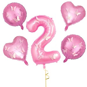 May include: Pink number two balloon with butterfly decorations, surrounded by three pink heart and round balloons with butterfly decorations.