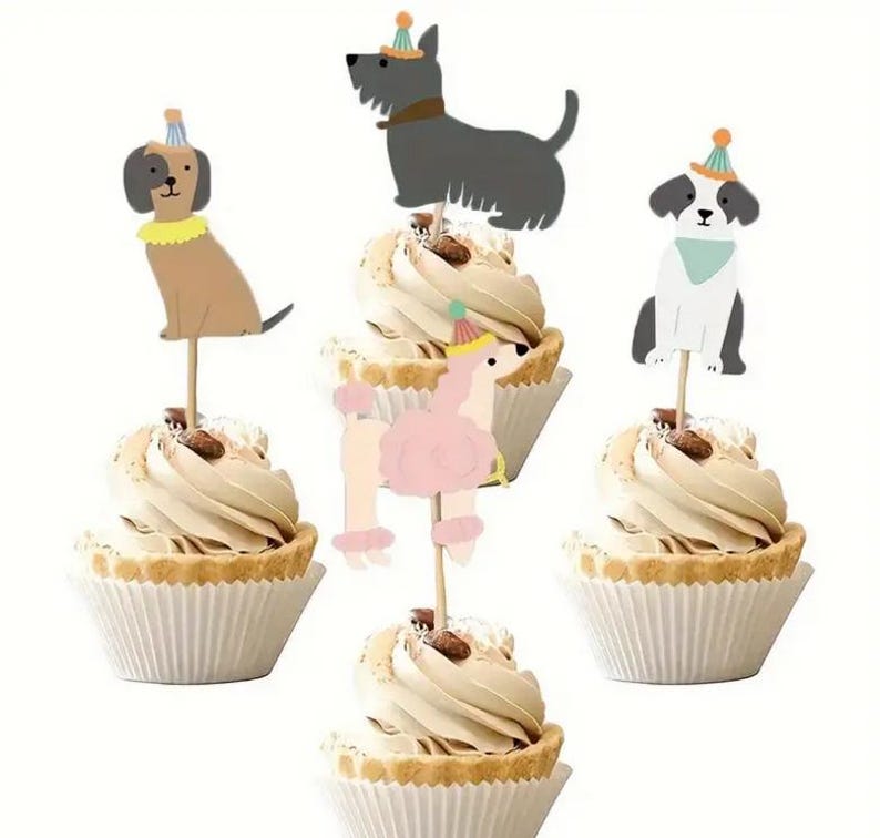 May include: Set of five cupcake toppers featuring various dog breeds wearing party hats. The toppers are made of cardstock and are perfect for adding a fun touch to your dog-themed party.