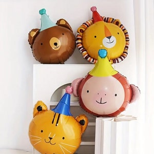 May include: Four colorful animal balloon decorations with party hats. The balloons are shaped like a bear, lion, monkey, and tiger. The balloons are all in a party setting.