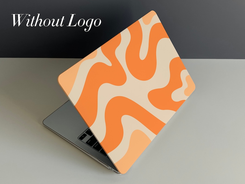 May include: A laptop computer with a light orange and cream abstract swirl pattern on the lid. The laptop is open and the keyboard is visible.