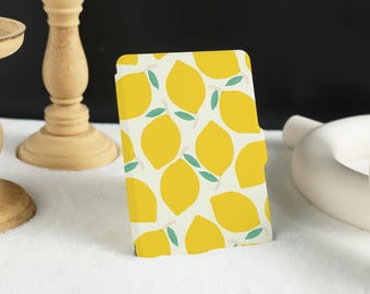 May include: A yellow and green patterned e-reader cover with a design of lemons and leaves.