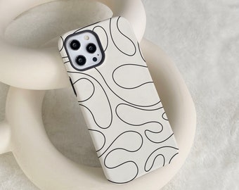 Può includere: Una custodia per telefono bianca con un design astratto nero. La custodia ha un ritaglio per l'obiettivo della fotocamera con tre cerchi neri.