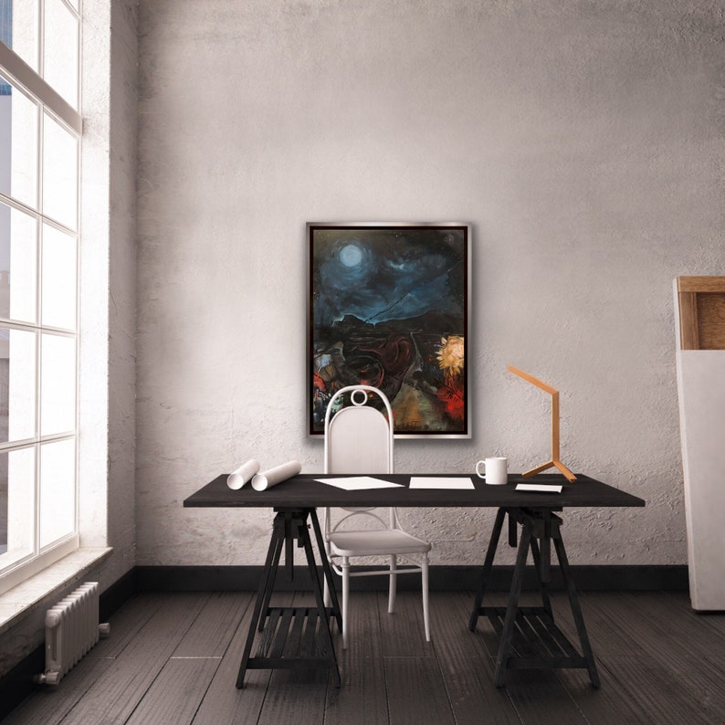 May include: A black wooden desk with two trestle legs, a white chair, a white ceramic mug, and a silver framed painting of a moonlit landscape.