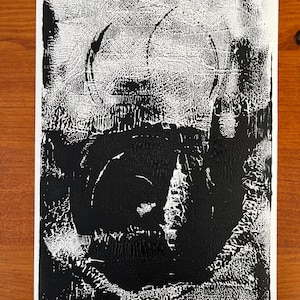 May include: Black and white abstract art print with a textured, circular design. The print is signed "Victoria Kandel C. 2023".