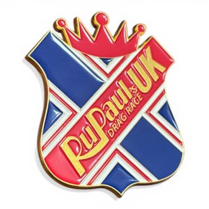 May include: A shield-shaped pin with a Union Jack design in blue, red, and white. The pin has a gold border and a red crown at the top. The text "RuPaul's Drag Race UK" is displayed in gold.