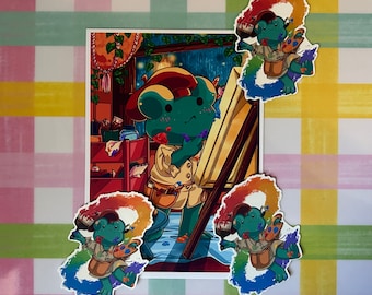 May include: Four colorful stickers featuring a green frog character holding a paintbrush and palette. The frog is wearing a brown hat and a brown vest. The stickers are on a pink and yellow checkered background.
