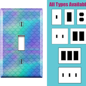 May include: A decorative light switch cover with a mermaid scale pattern in shades of blue, green, and purple. The cover has a single toggle switch and two screws. The text "All Types Available" is displayed on the right side of the image, with examples of different switch types.