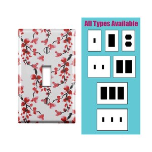 Peut inclure: Plaque d'interrupteur blanche avec un motif floral à l'aquarelle de fleurs rouges et de branches noires. L'interrupteur est de type à bascule. Un panneau séparé montre différents types de prises et d'interrupteurs. Le texte indique "All Types Available."