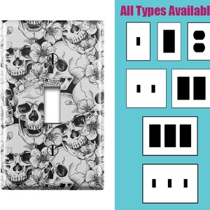May include: A light switch cover with a black and white skull and floral pattern. The image shows different types of light switch covers available, including single, double, and triple switch covers. "All Types Available" is written at the top of the image.