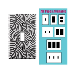 May include: A black and white zebra print light switch cover plate. The text "All Types Available" is displayed above a variety of switch and outlet plate styles.