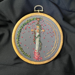 Hand embroidered fantasy artwork featuring a sword entwined with roses and greenery (12 cm)