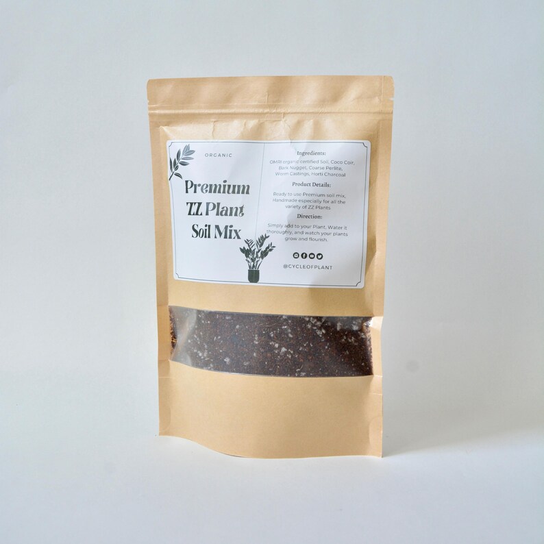 May include: A brown paper bag with a clear window showing a dark brown soil mix. The bag has a white label that says "Organic Premium TZ Plant Soil Mix" and lists the ingredients and directions for use. The label also includes the social media handle @CYCLEOFPLANT.