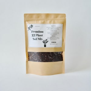 May include: A brown paper bag with a white label that says "Premium ZZ Plant Soil Mix" and lists the ingredients and directions for use. The bag is filled with dark brown soil.