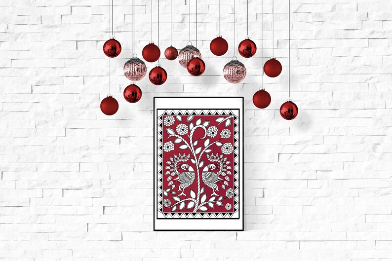 May include: A framed print of a red background with a white design of two peacocks and a tree. The print is surrounded by a black frame and hanging on a white brick wall. Red Christmas ornaments are hanging from the ceiling above the print.