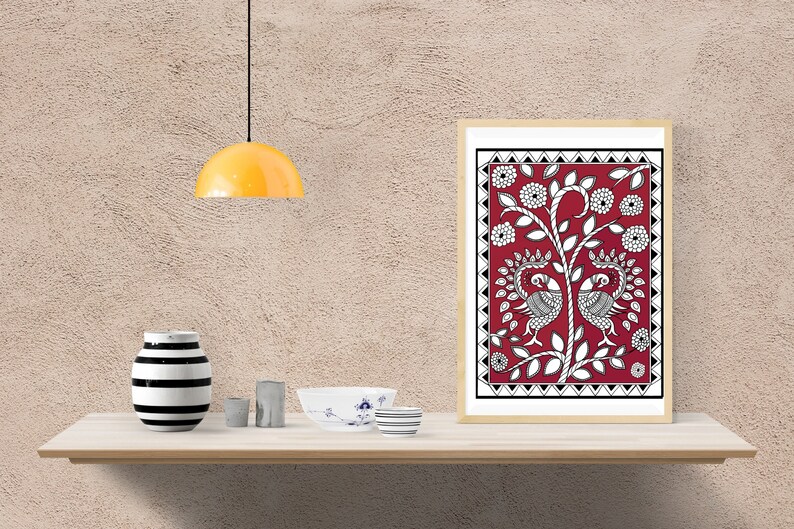May include: A framed print of a traditional Indian folk art painting depicting two peacocks on a tree with red, white, and black colors.