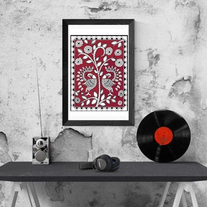 May include: A framed black and white illustration of two peacocks on a red background with white floral designs. The frame is black and the illustration is in a square format.