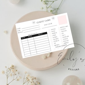May include: A white client card with the text "CLIENT CARD" and sections for name, phone, appointments, and services. The card includes checkboxes for nail services and a pink accent. The card is on a beige plate.