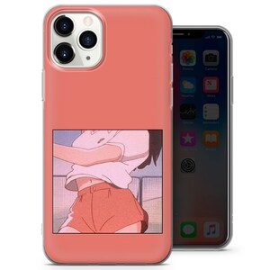 May include: A pink and white phone case with a clear back. The case features a picture of an anime character wearing a pink shirt and orange shorts. The character is standing in front of a blue and white background.