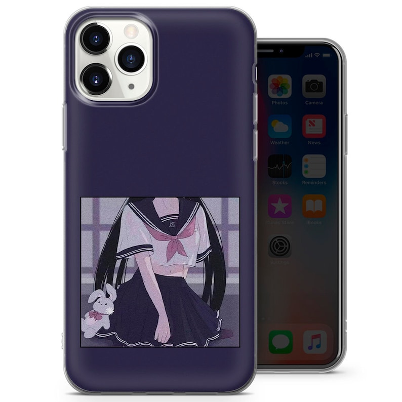 May include: A clear phone case with a purple background and a graphic of an anime girl wearing a sailor uniform and holding a stuffed bunny. The girl has long black hair and is wearing a white shirt with a red bow tie. The case is designed for an iPhone.